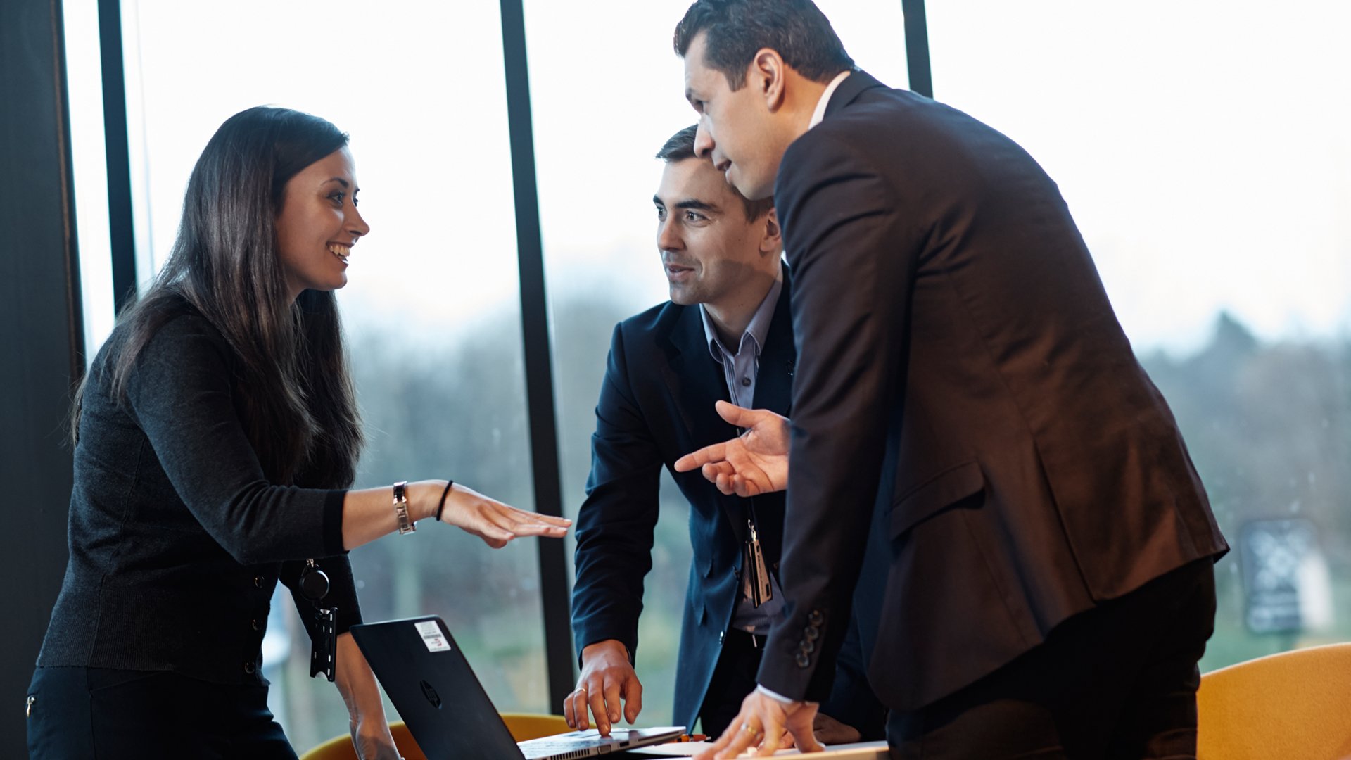 Consultants collaborating around a project table